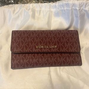 Michael Kors Burgandy womens button snap wallet.